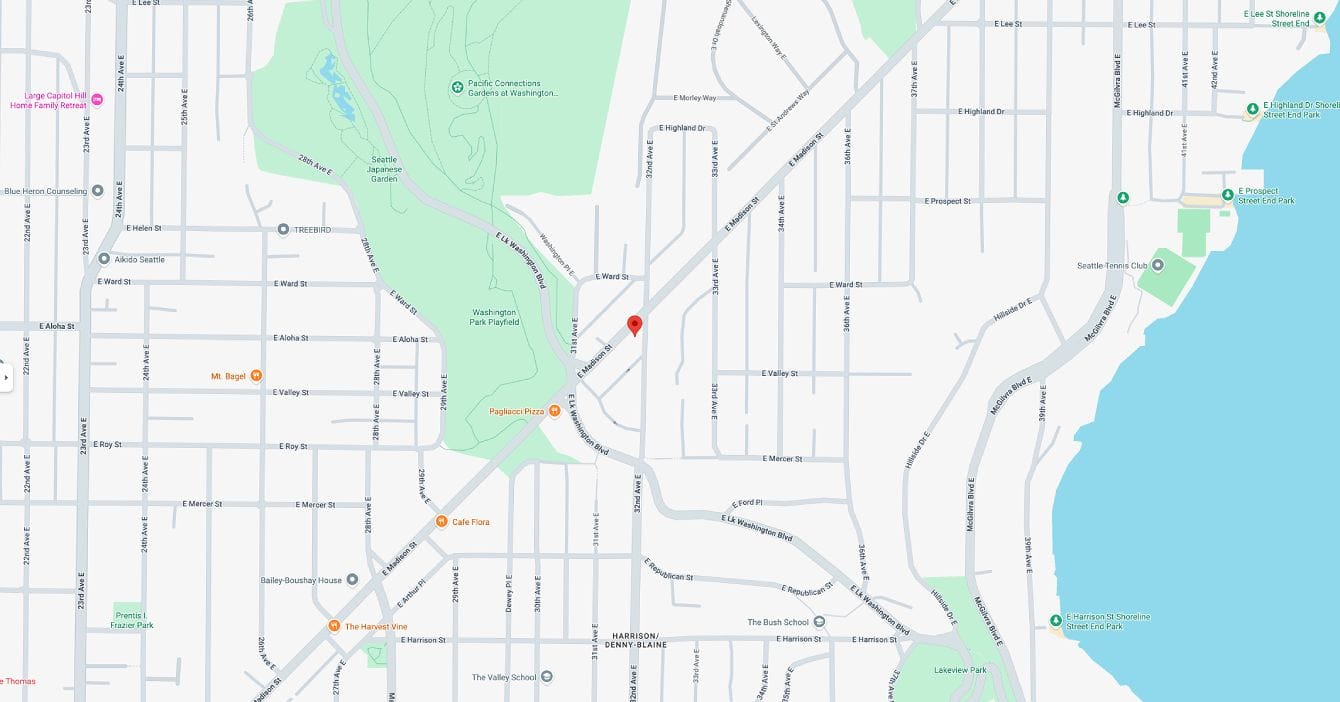 A map showing city streets near a waterfront, with parks to the west and a red location marker at a street intersection in the center. Landmarks and street names are visible, highlighting clinics with certified practitioners specializing in menopause medical care.